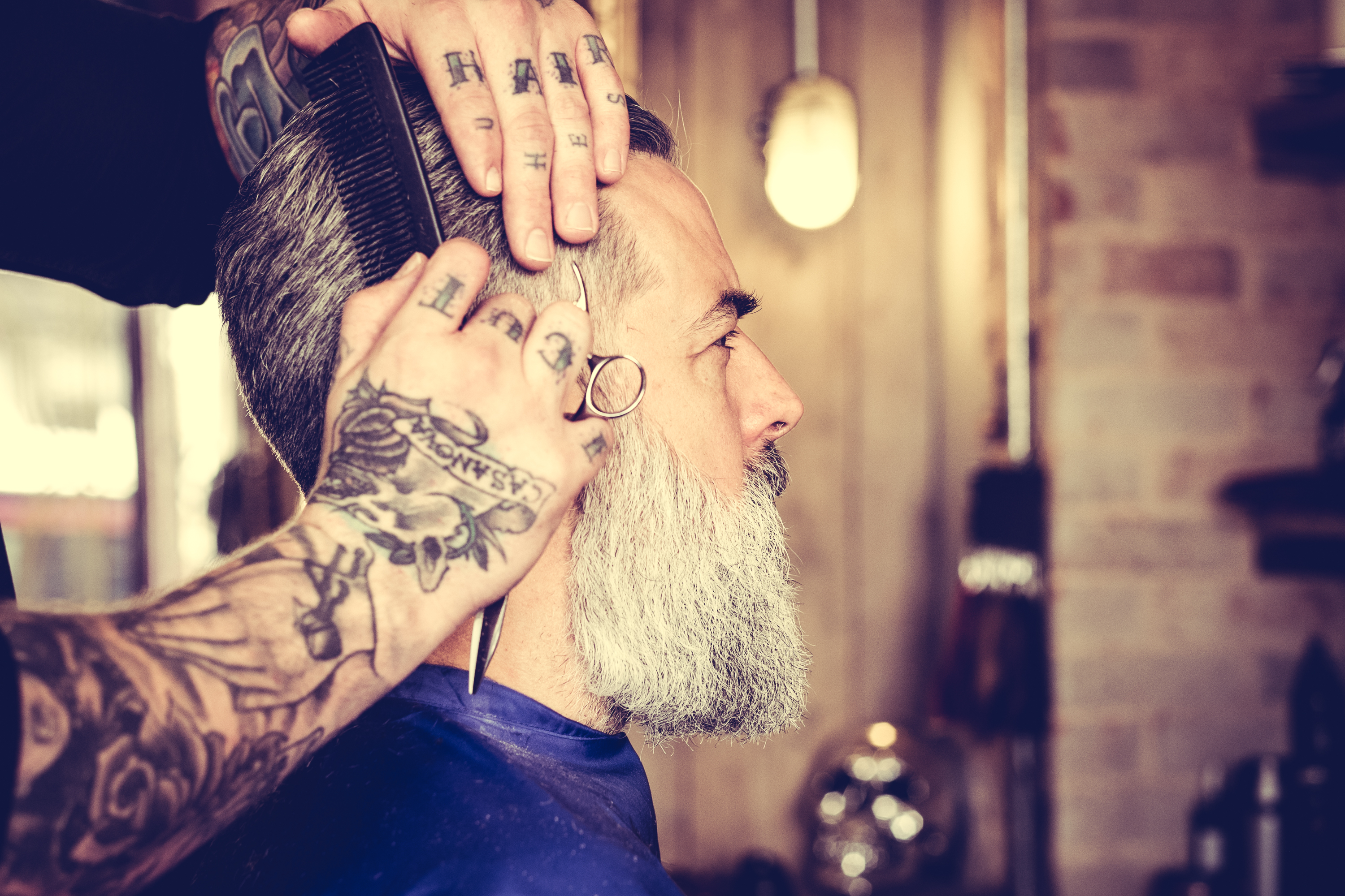 Man having hair styled at the barbers