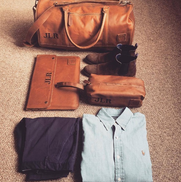 Clothes fodled with leather bag for weekend away
