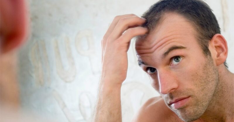 Man going bald in the mirror - image from Idle Man