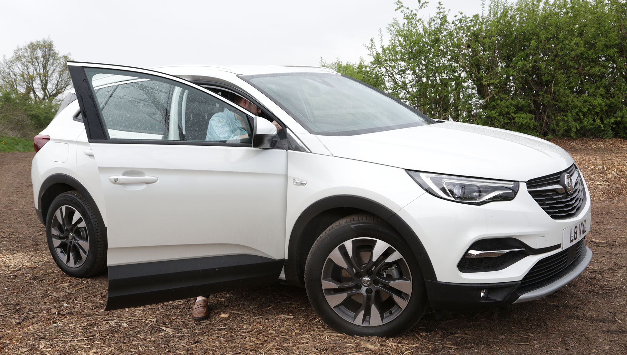 Man getting in a 4x4, Vauxhall Grandland X, White Jeep, New Car, Car in Field