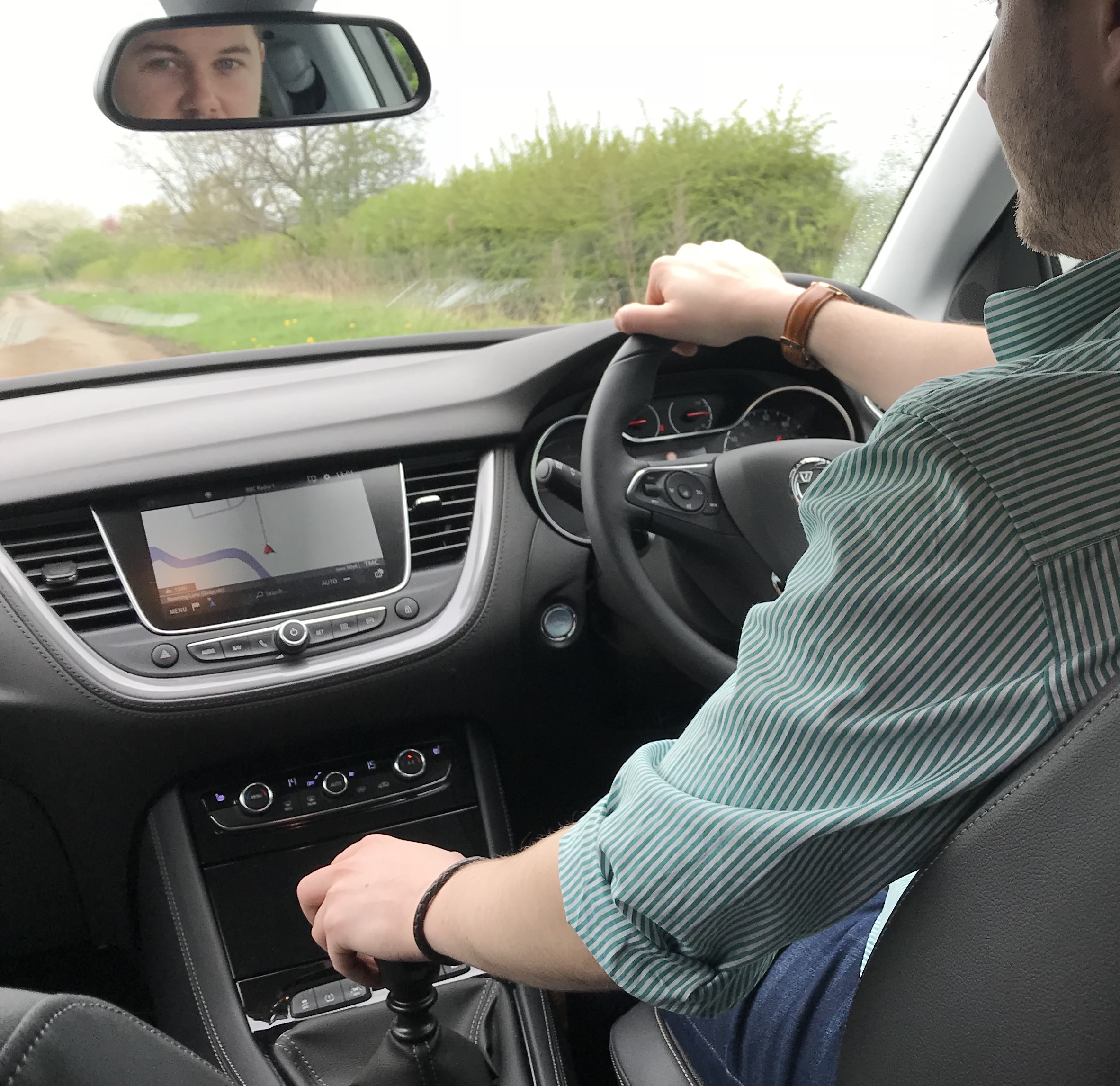 Man driving 4x4, SUV, Vauxhall Grandland X, Sat Nav in car, inside a car