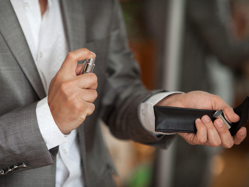 Man spraying aftershave, aftershave, perfume, man in suit, smell nice